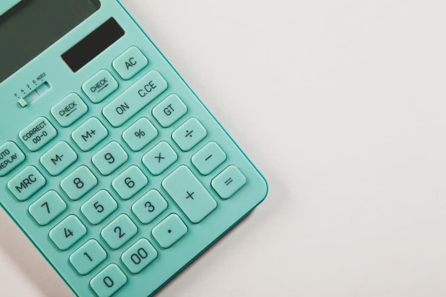 Mint green bookkeeping calculator on a clean background
